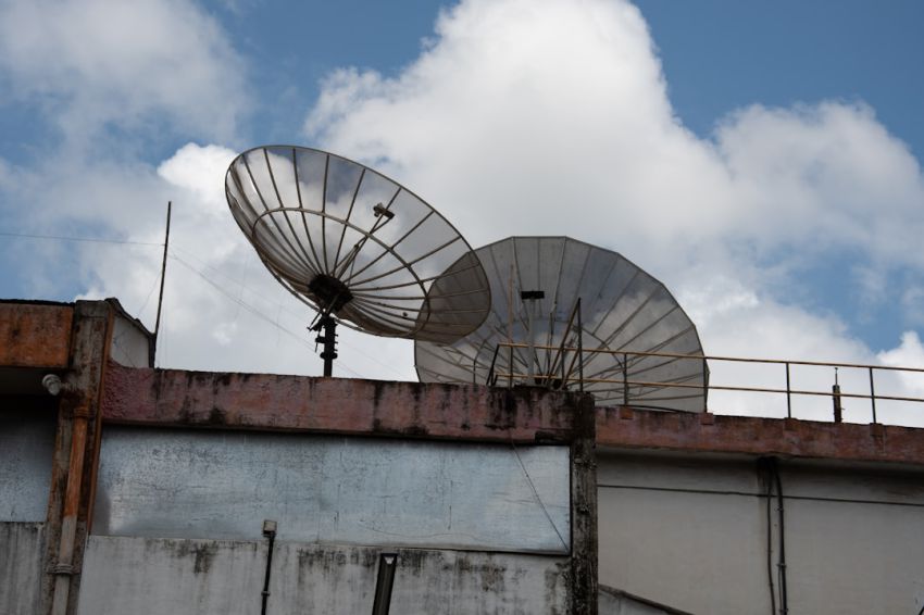 Satellite Antenna - a couple of satellite dishes sitting on top of a building