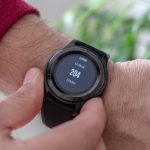 Wearables - person wearing round black smartwatch