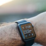 Wearables - person wearing black smartwatch with black band