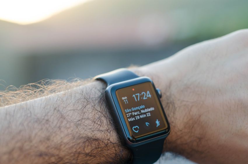 Wearables - person wearing black smartwatch with black band