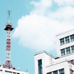 Cell Tower - white concrete building with red tower