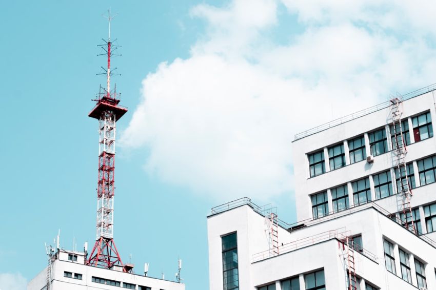 Cell Tower - white concrete building with red tower